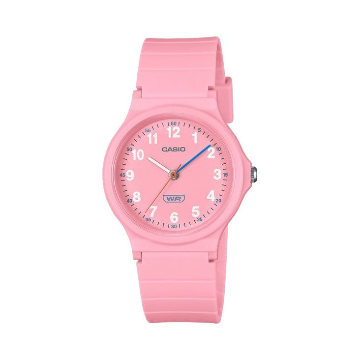 Casio watch with a pink silicone strap and a matching pink round dial, featuring white Arabic numerals and blue hands, shown against a plain white background.